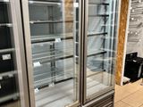 two refrigerators that are sitting in the middle of a room