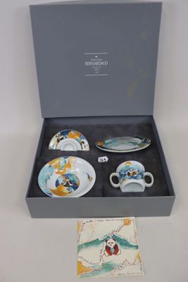 trois tasses et soucoupes dans une boîte posée sur une table