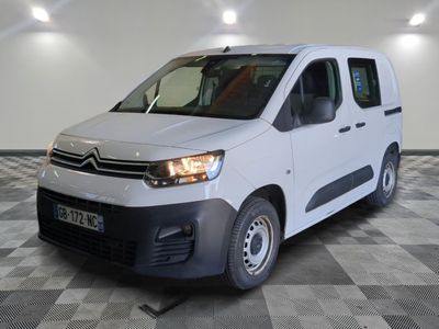 the white van is parked on a checkered floor in a room