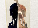 a sculpture of a violin and a violin case on a table
