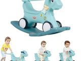 a small child riding a blue rocking horse