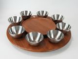 a wooden plate with six bowls on it on a white background