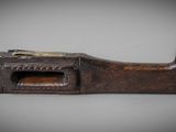 a close up of a wooden pipe cutter on a gray surface