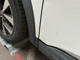 a close up of a car with a tire on the side of the road