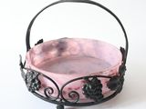 a small pink bowl with black flowers on it