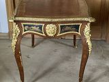 a wooden table with a blue and gold design on it