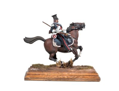 statue of a man riding a horse on a wooden base