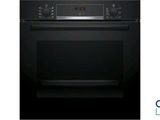 an image of a black oven with the door open on a white background