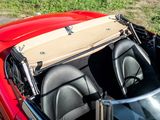 two seats in the back of a red sports car