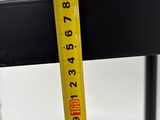 a measuring tape on the back of a black chair