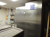 a refrigerator in a kitchen with a lot of counter space