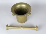 an old brass mortar with a wooden handle on a white background