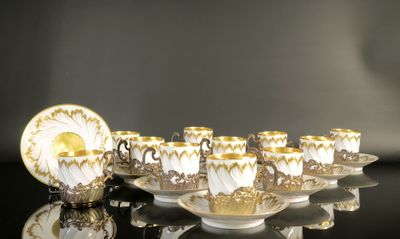 several cups and saucers are lined up on a black table