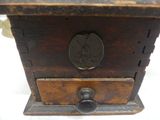 a small wooden box with a coin on it
