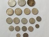 a close up of a bunch of coins on a white surface