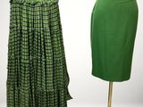 two green skirts on a mannequin stand in front of a white background