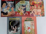 Plusieurs albums de BD sont alignés sur une surface blanche