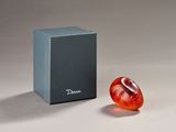 a glass object sitting next to a box on a table