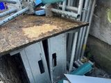 a lot of pipes and pipes on the ground next to a building