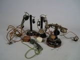 many different types of telephones and cords on the table