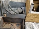 a metal box with tools in it sitting on the floor