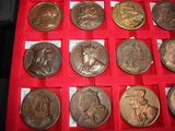 a lot of coins that are in a red display case