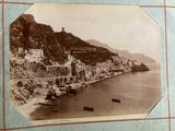 a black and white photo of a small town on the coast