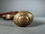 pair of antique brass door knobs on a gray surface