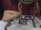 a small table and two stools in the corner of a room