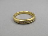 a close up of a gold ring with diamonds on it