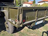 an image of a military truck parked in the grass