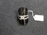 a ring that is sitting on a table next to a price tag