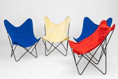 three folding chairs with red, blue and yellow covers on them