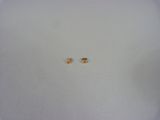 two small yellow bugs are sitting on a white surface