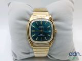 a close up of a gold wrist watch on a pillow