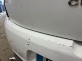 a close up of a white car with a number plate on it
