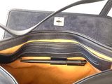 a purse with a pen inside of it on a table