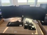 a desk with two computer monitors and a keyboard on it