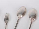four spoons and a fork on a white surface