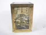 a gold clock that is sitting on a white surface