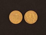 two gold coins, one of which has a head and the other of which has a crown on it