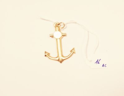 a small gold anchor with a white pearl on it