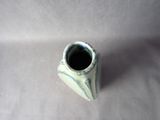 a small white vase sitting on a white surface