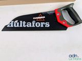 a black and red hand saw sitting on a table