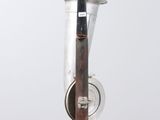 a silver vase with a wooden handle hanging from it