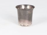 silver plated shot glass with a silver rim on a white background