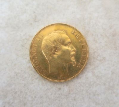 a close up of a gold coin with a man ' s face on it
