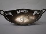 silver plated serving dish with ornate design on a stand
