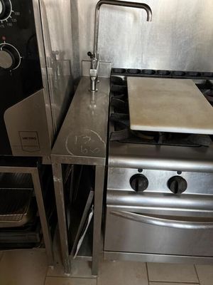 a stainless steel stove and oven in a small kitchen