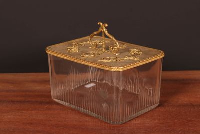 an image of a glass box with a gold decoration on it